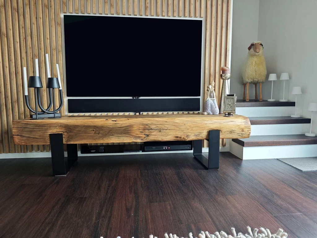 Lowboard aus historischem Eichenbalken vor einer Wand mit Holzlamellen